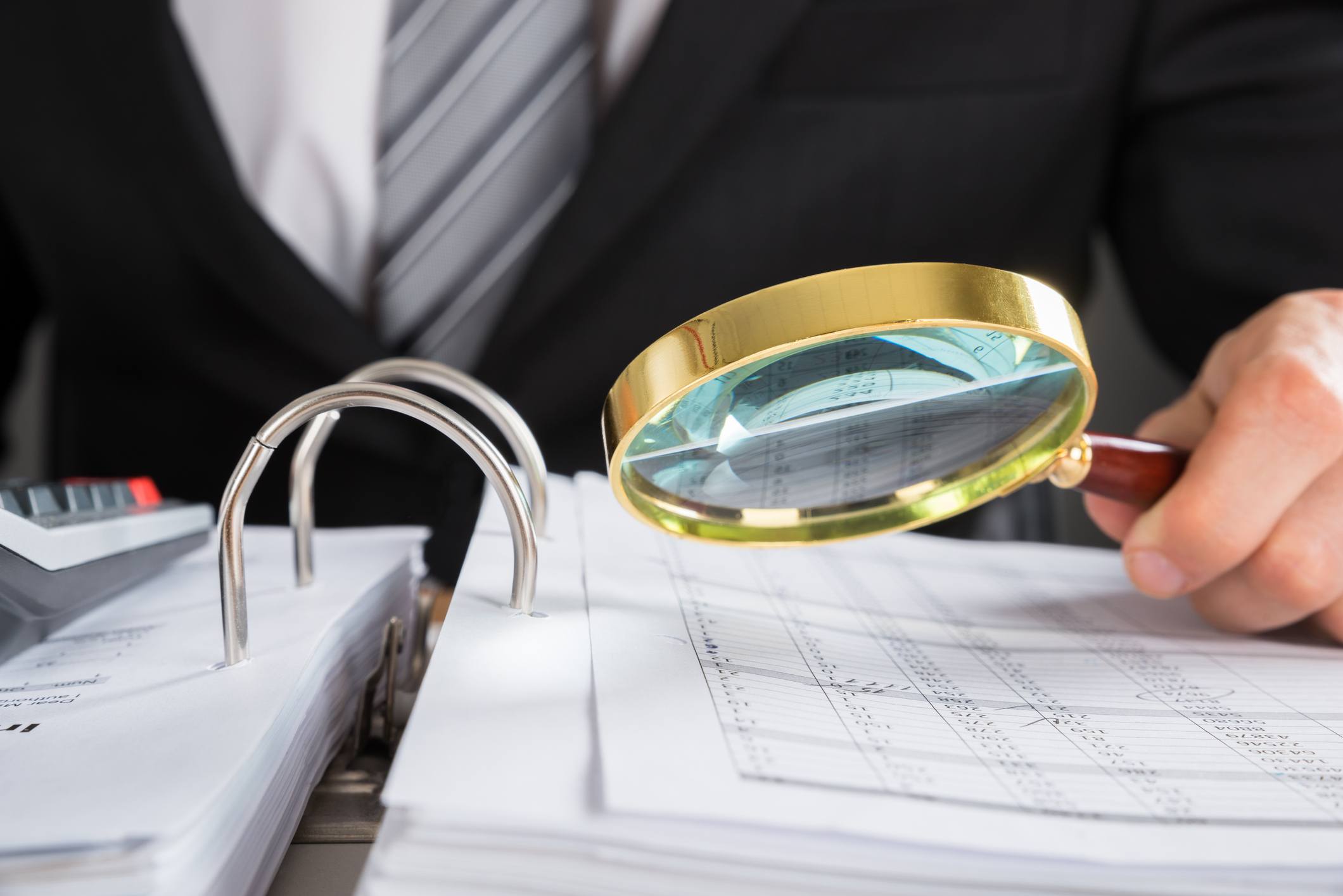 Examining tax audit with magnifying glass