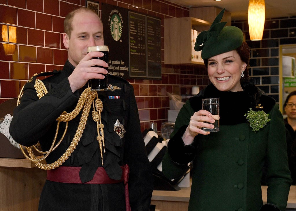 Prince William, Duke Of Cambridge, Colonel of the Irish Guards drinks a pint of Guinness next to Catherine, Duchess of Cambridge