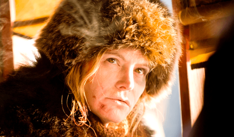 Jennifer Jason Leigh wearing a fur jacket in 'The Hateful Eight'. Jennifer Jason Leigh wearing a fur jacket in 'The Hateful Eight'.