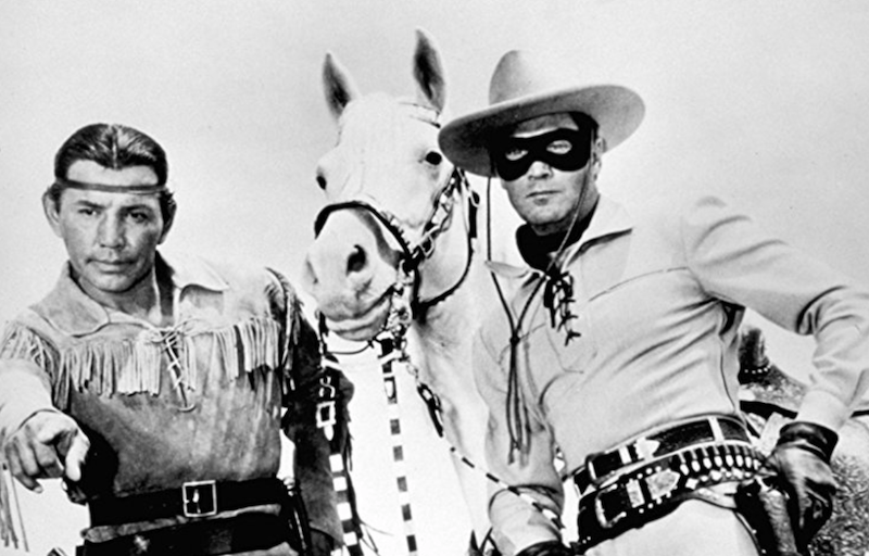 The cowboy and Indian standing with a white horse. The cowboy and Indian standing with a white horse.