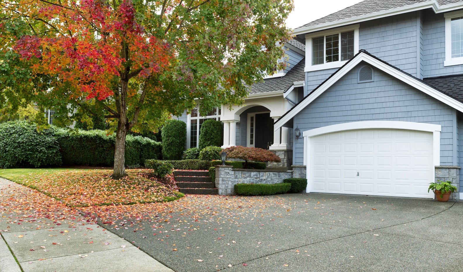 Front yard of house with autumn trees