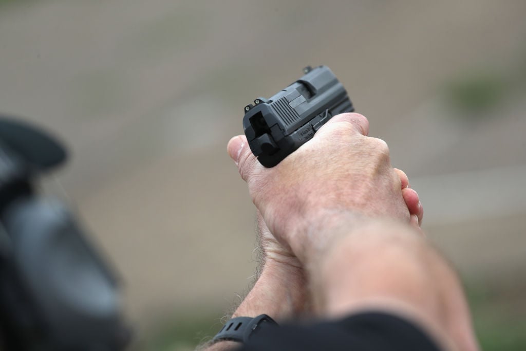 A U.S. Customs and Border Protection agent fires an H&K P2000 handgun