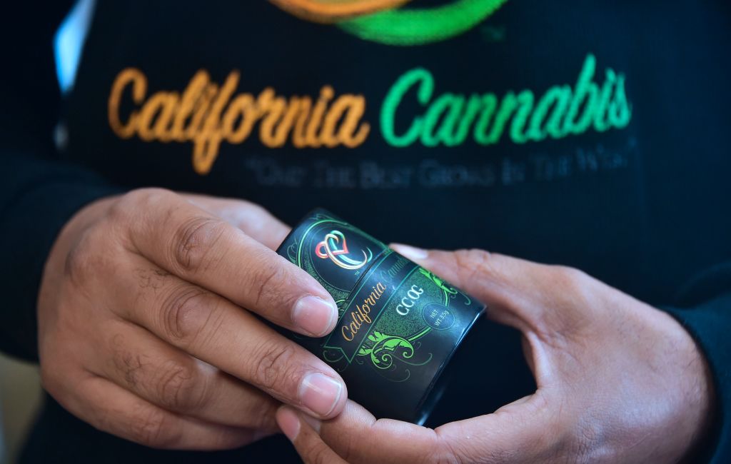 Cannabis entrepreneur Virgil Grant holds a 3.5 gram container for the medical marijuana