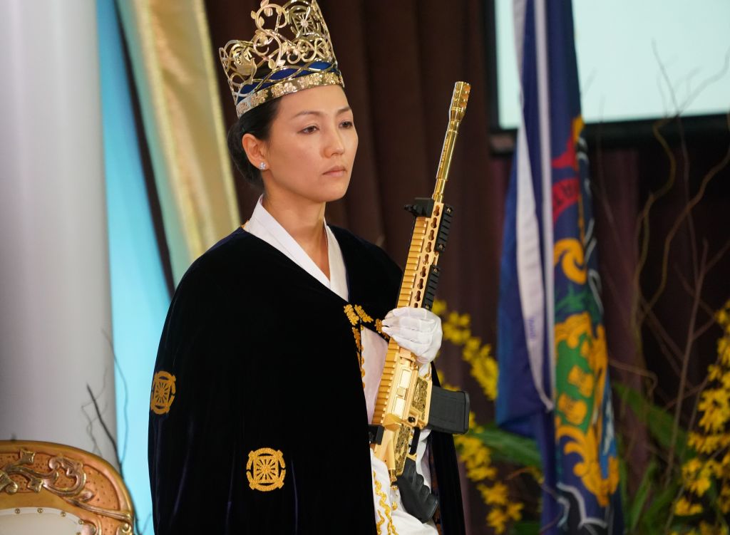 Rev. Yeon Ah Lee Moon, wife of Rev. Hyung Jin Moon, holds weapon as worshippers at World Peace and Unification Sanctuary attend services