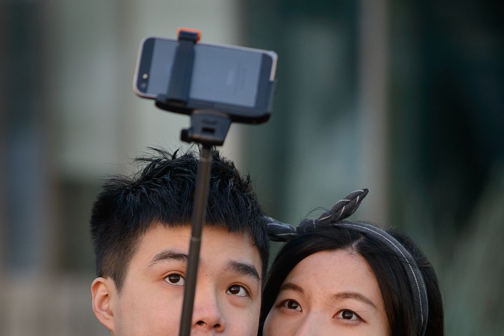 Selfie couple taking selfie with selfie stick