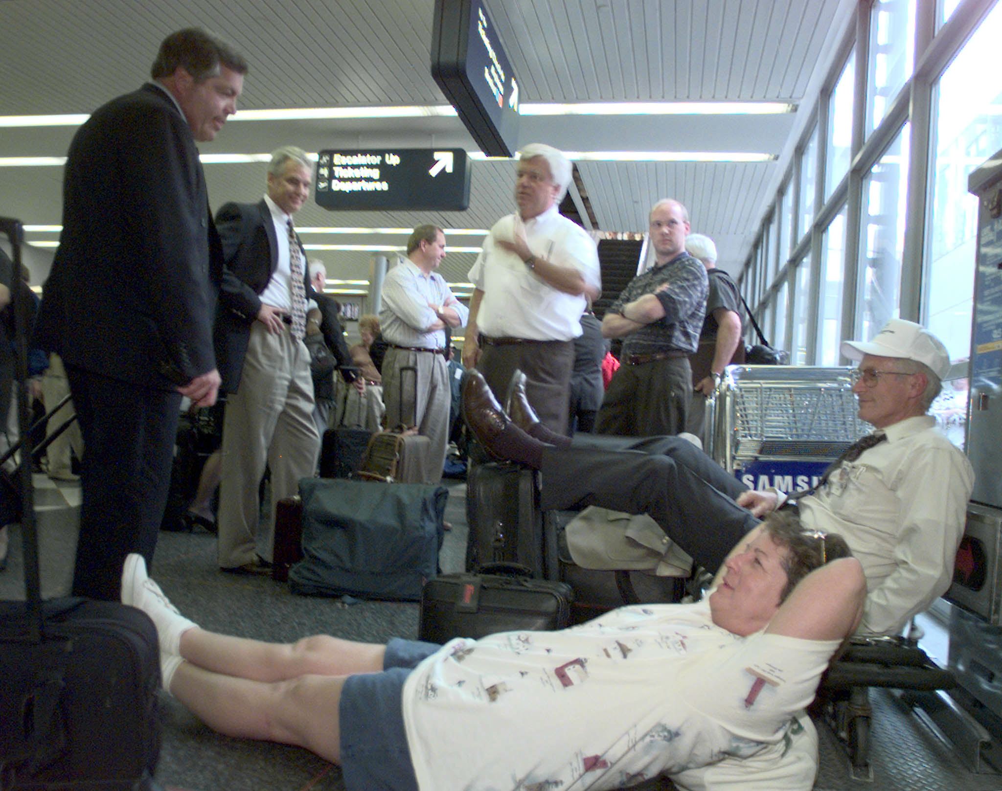People wait at the airport in the 90s