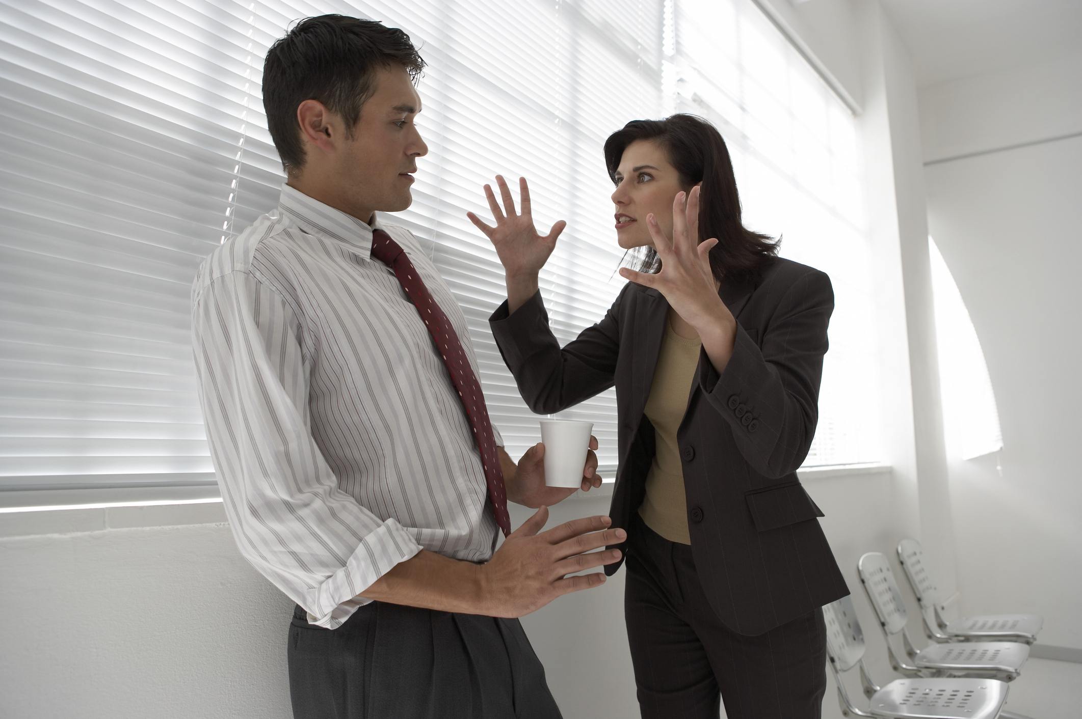 Angry Businesswoman yelling at a businessman