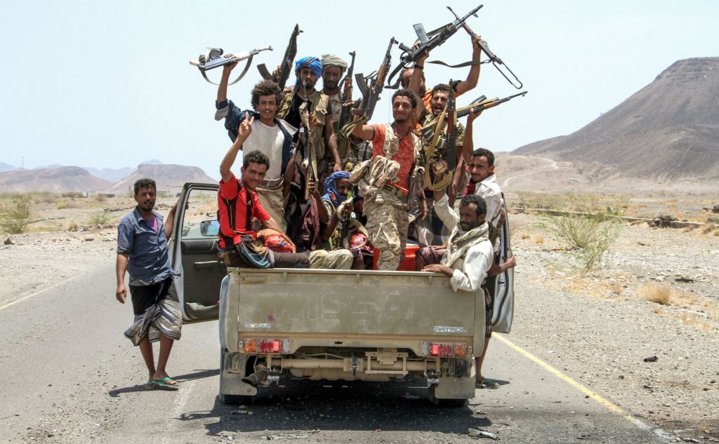 Rebels in a truck waving guns in the air