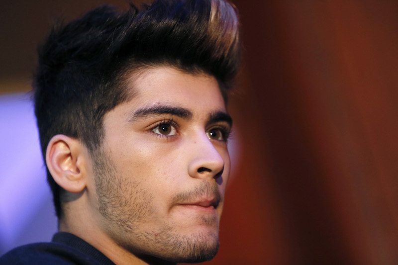 Zayn Malik smiling slightly as he wears a black shirt. Zayn Malik smiling slightly as he wears a black shirt.