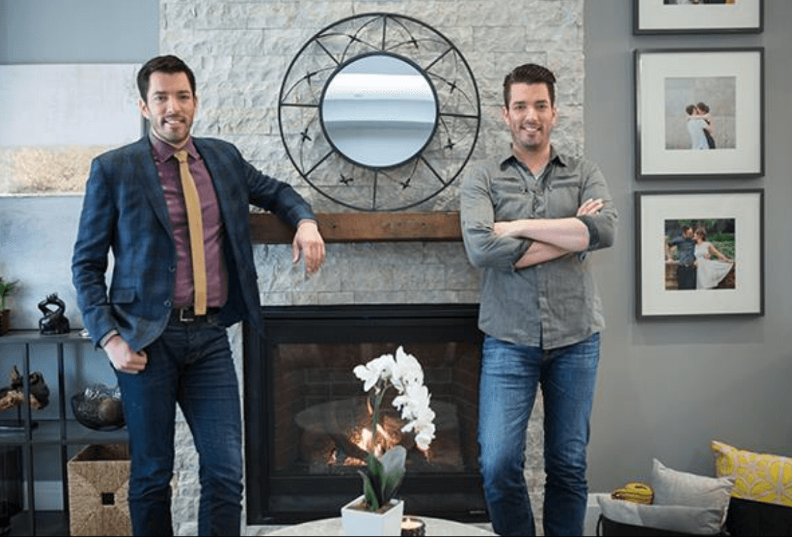 Property Brothers in front of a fireplace