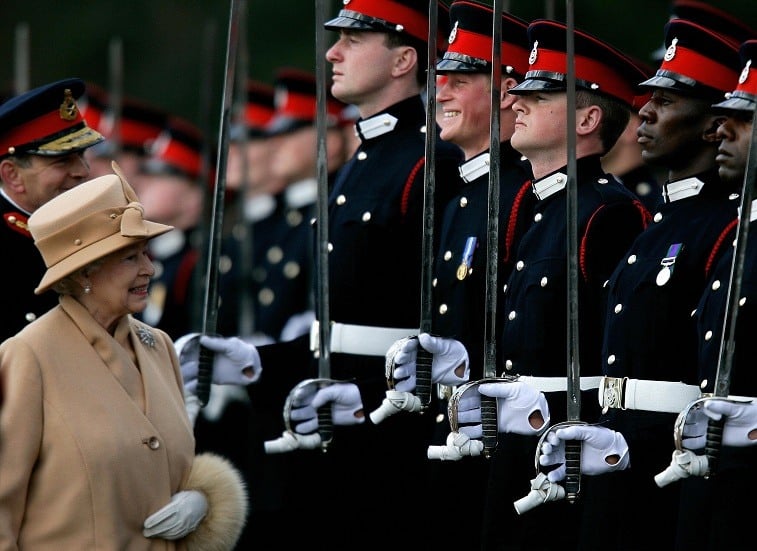 Britain's Queen Elizabeth II smiles with her grandson Prince Harry during the Sovereign's Parade at the Royal Military Academy in Sandhurst, southern England, April 12, 2006