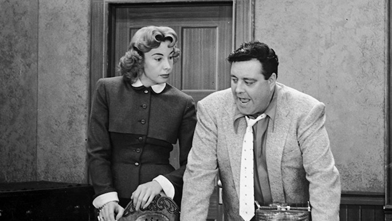 Alice and Ralph speaking in their kitchen. Alice and Ralph speaking in their kitchen.