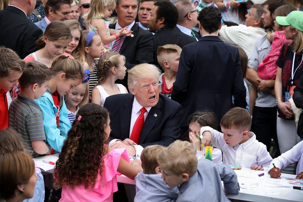 Trump with kids in a large crowd