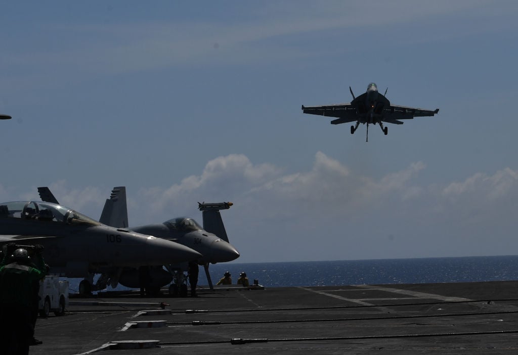Fighter jet landing on an aircraft carrier