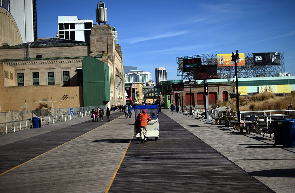 A man moves passengers on a "push cab" along the boardwalk in Atlantic City.