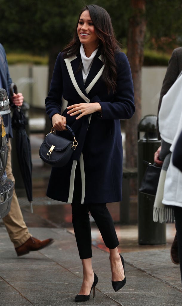 Britain's Prince Harry's fiancee US actress Meghan Markle greets well-wishers as she arrives with the prince at Millennium Point to attend an event