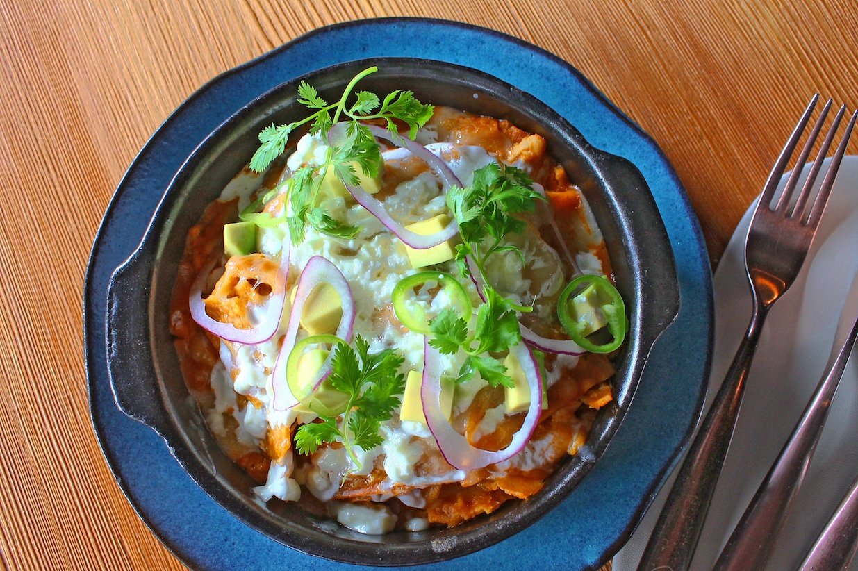 Chilaquiles mexican dish wooden table