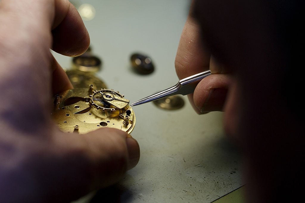 Watchmaker repairs a pocket watch