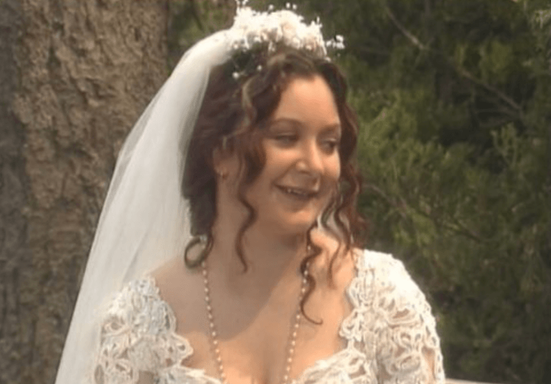 Darlene smiling while in her wedding dress. 