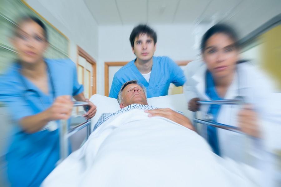 Team of doctors running in a hospital hallway
