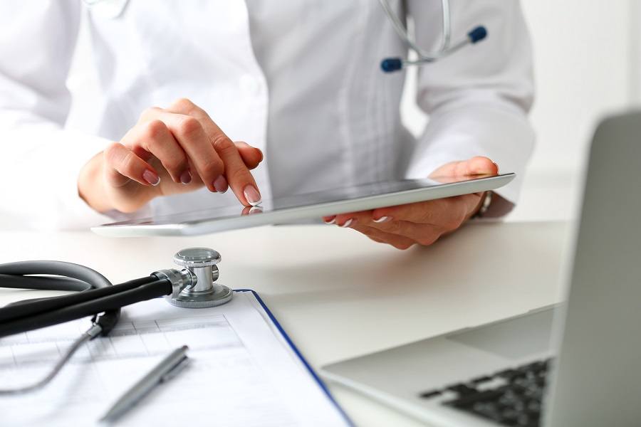 Doctor checking tablet
