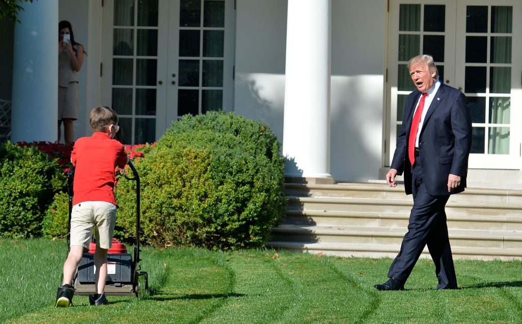 Trump watches Frank Giaccio, 11, of Falls Church, Virginia, as he mows the lawn