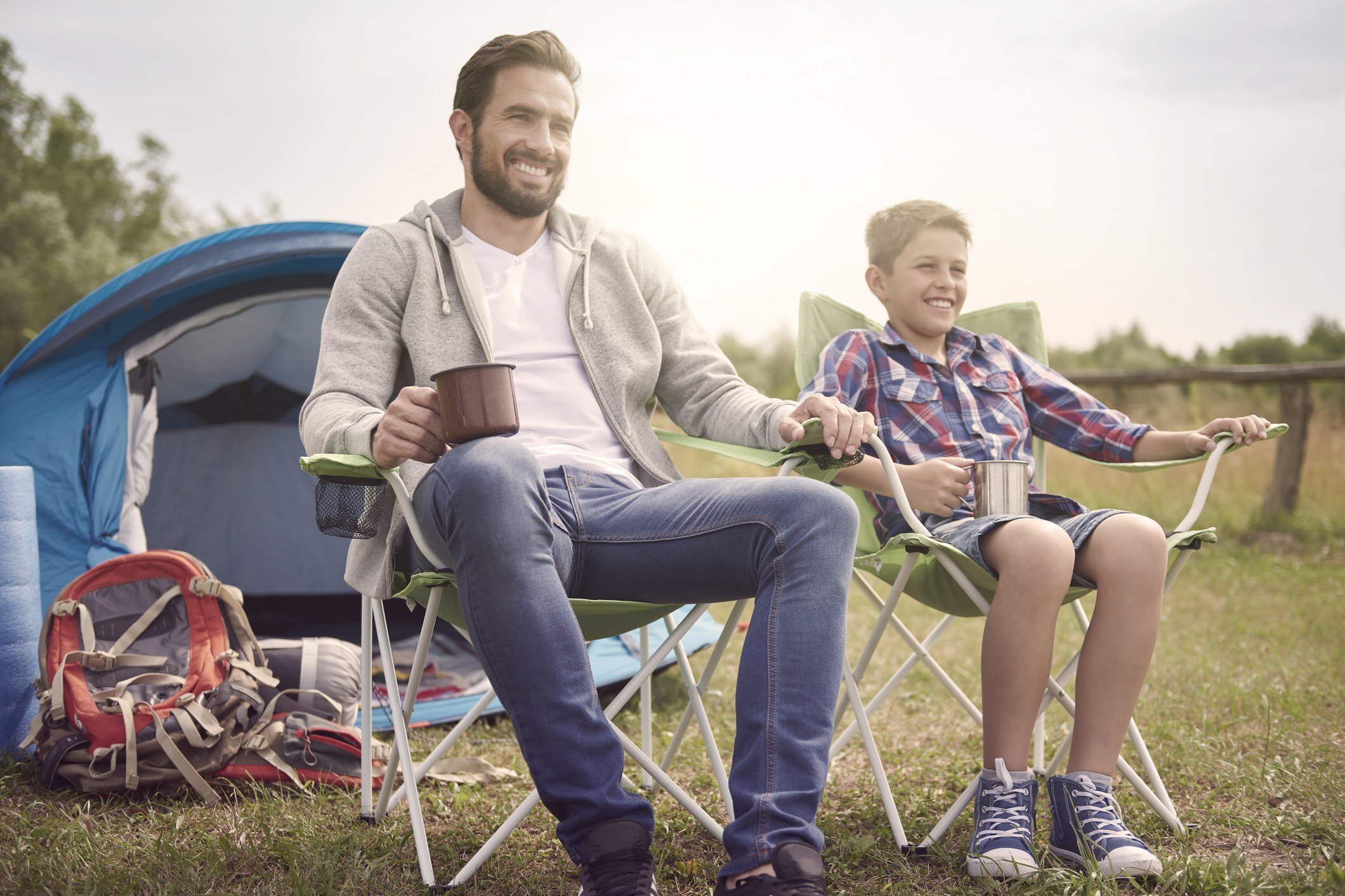 Father and son in camping chairs