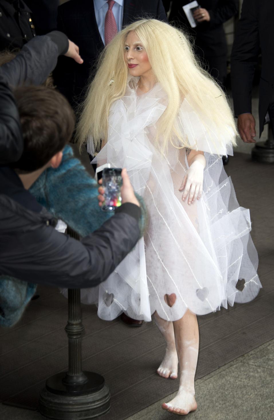 US singer Lady Gaga greet fans as she leaves the Ritz Carlton hotel on Potsdamer Platz in Berlin