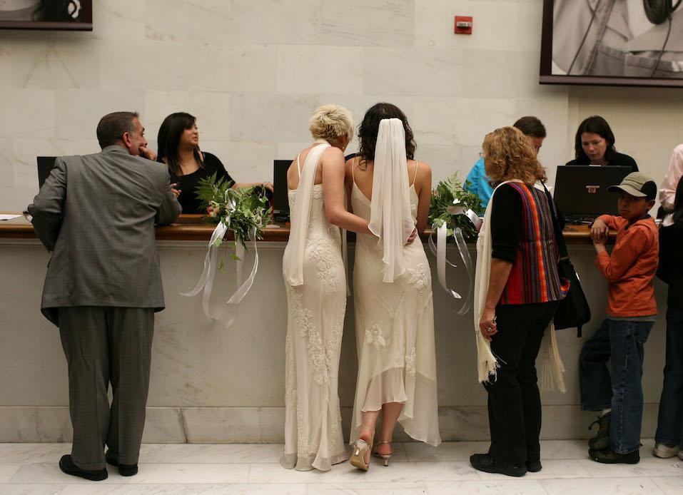Same-sex couple Amber Weiss and Sharon Papo stand in line to receive their marriage license before getting married