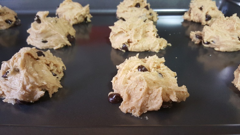 Chocolate chip cookie dough on baking sheet.