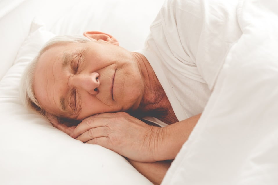 old man sleeping in bed