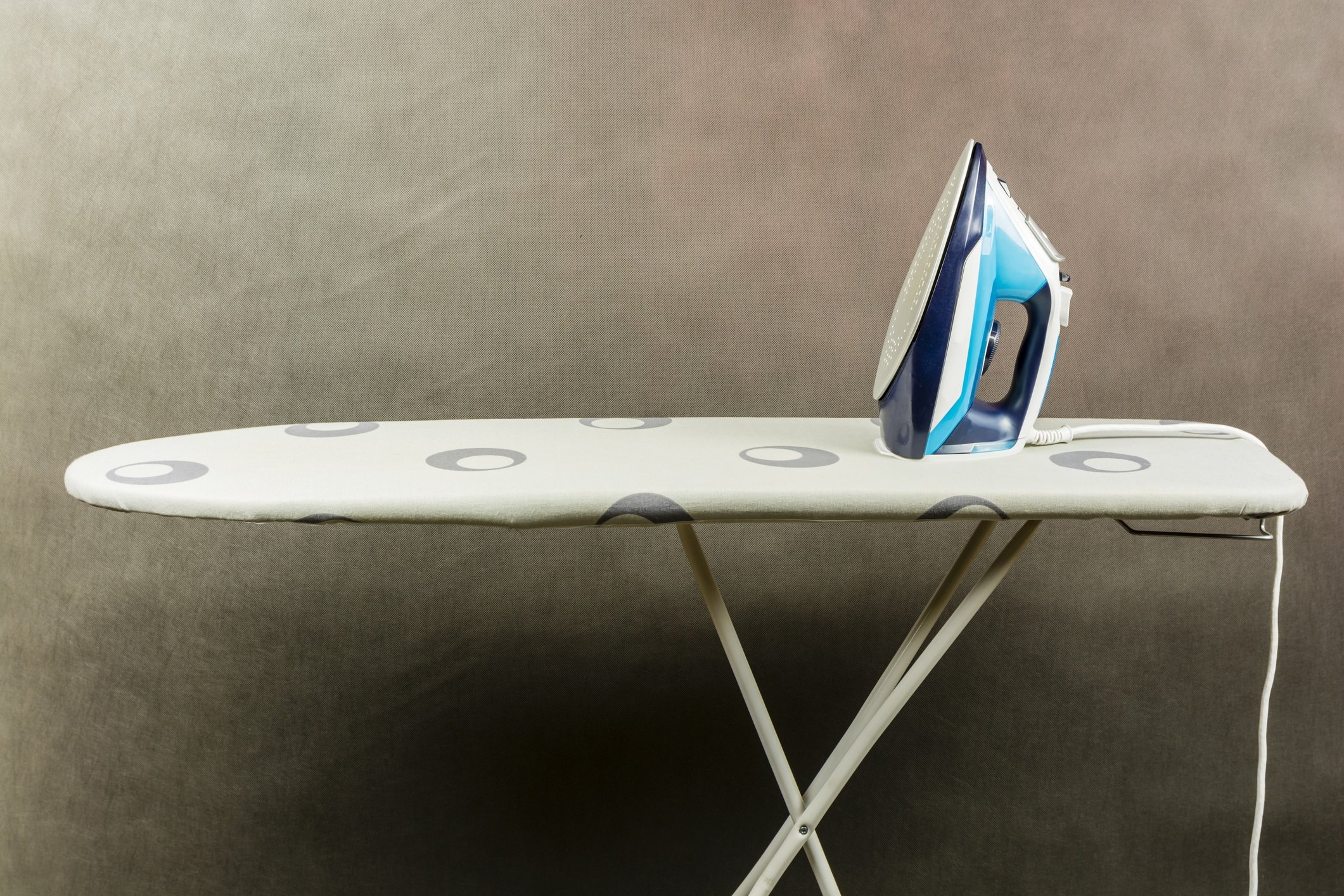 Clothes iron on the ironing board.
