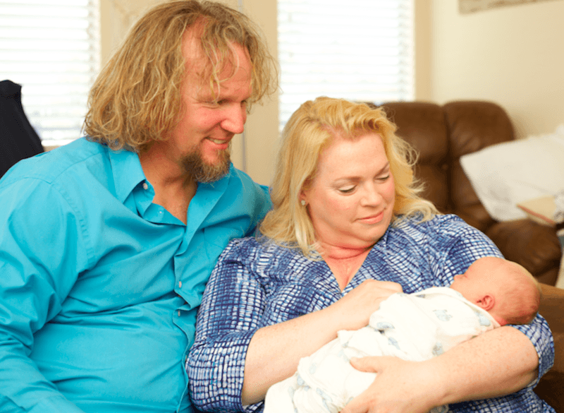 Janelle and Kody Brown from "Sister Wives" holding a baby