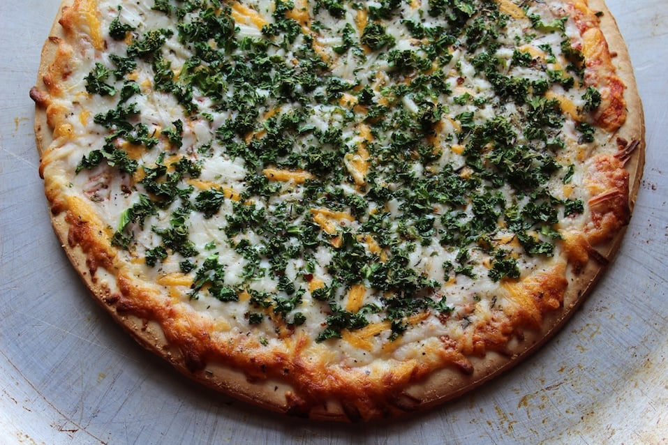 Pizza covered in fresh kale
