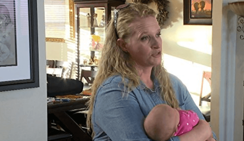 A wife carries her baby. A wife carries her baby.