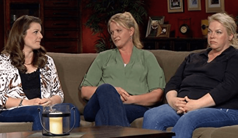 Kody's three wives sitting on a couch as they talk to each other. Kody's three wives sitting on a couch as they talk to each other.