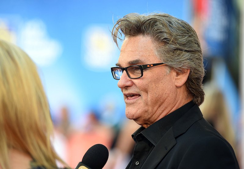 Kurt Russell being interviewed by a reporter on a red carpet. Kurt Russell being interviewed by a reporter on a red carpet.