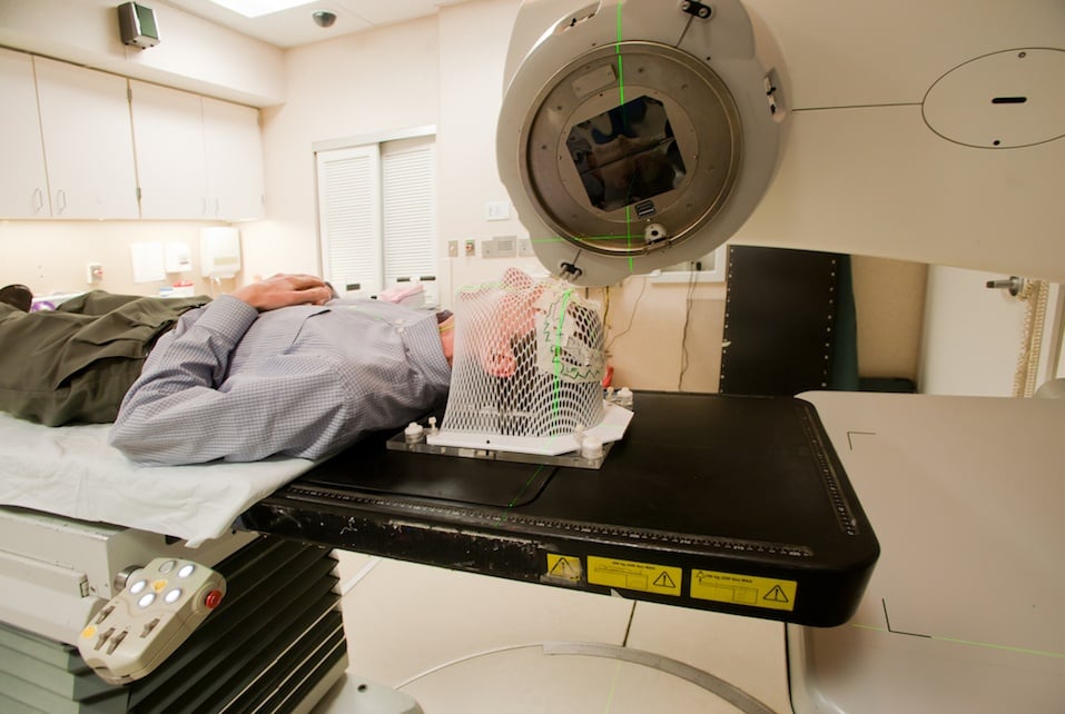 Male patient wearing a facial mask undergoing radiation
