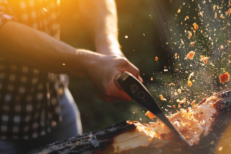 Man cutting wood with axe Man cutting wood with axe