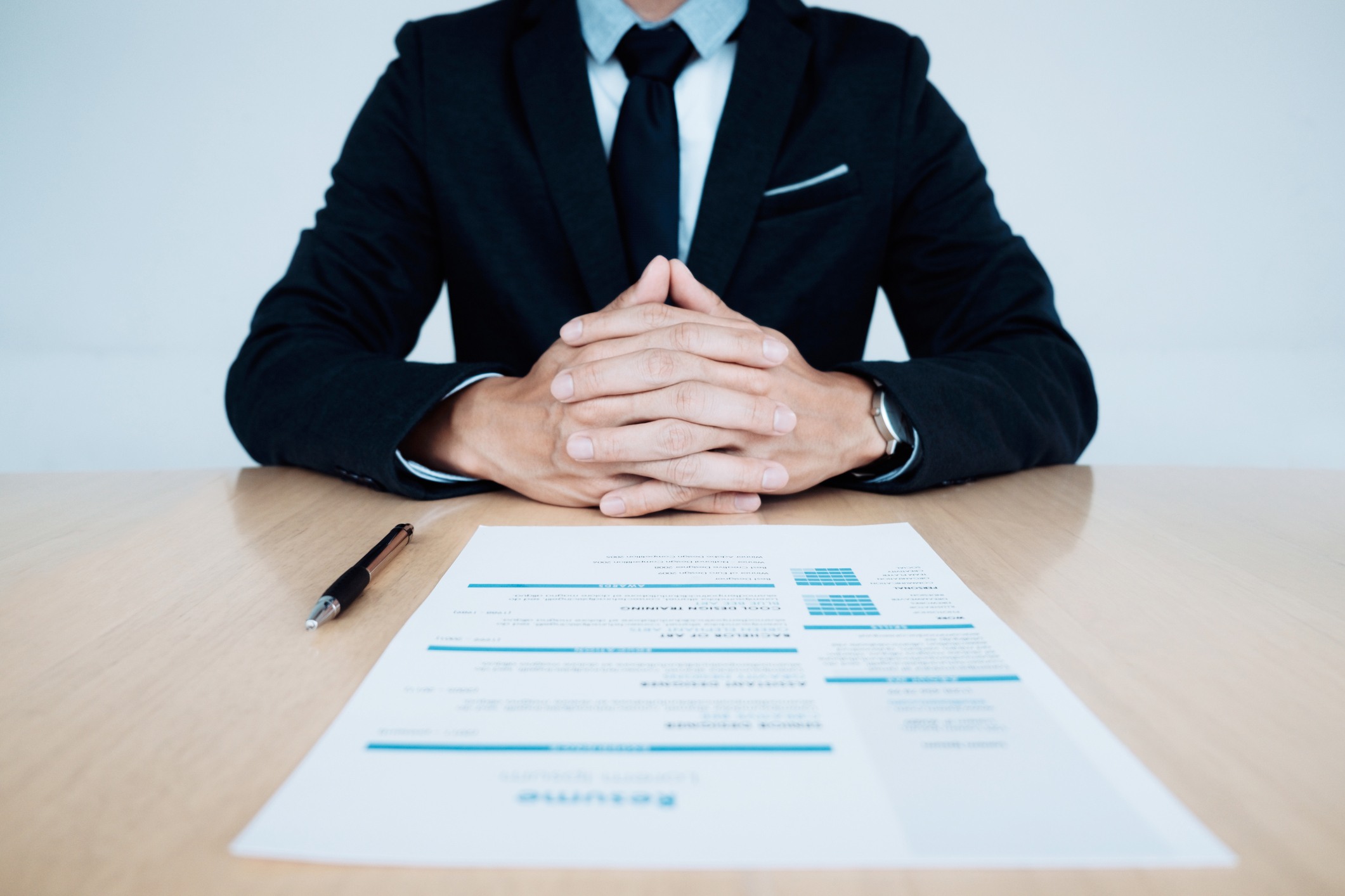 Business Job interview. HR and resume of applicant on table.