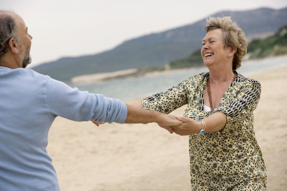 Mature couple dancing on beach