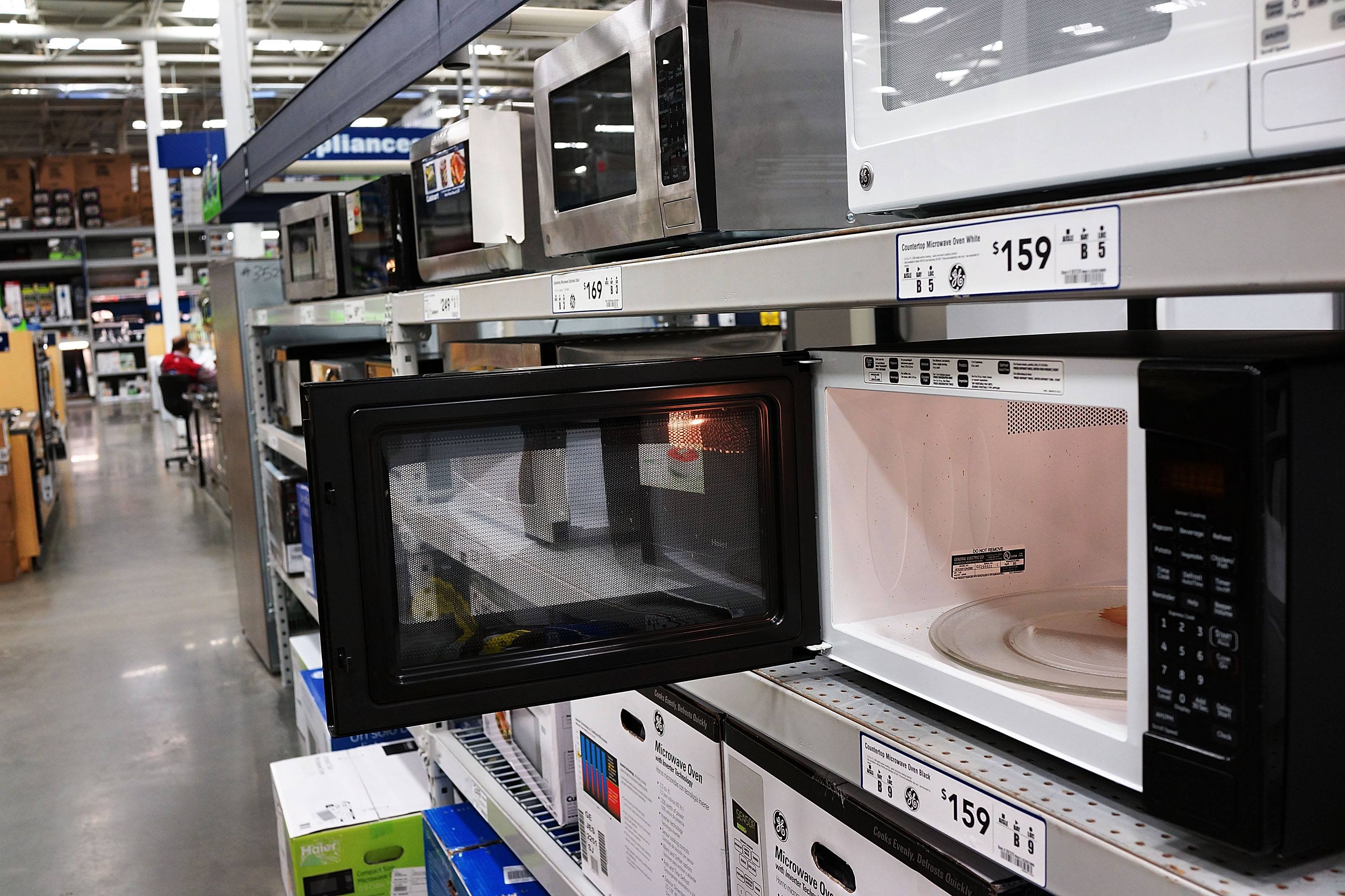 Microwave ovens are on display in a home furnishing store