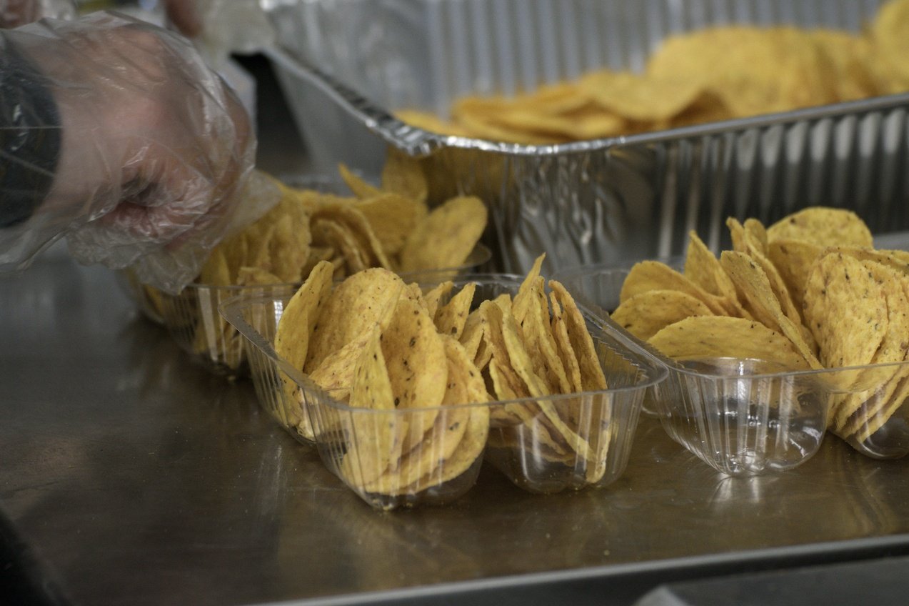 Plastic Gloved Hand Preparing Concession Nachos Tortilla Chips Snack Food