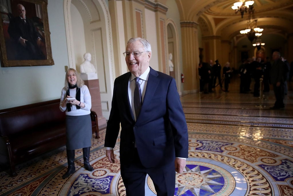 Former U.S. Vice President Walter Mondale walks outside the U.S. Senate chamber