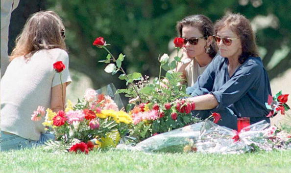 Murder victim Nicole Brown Simpson's mother Juditha (R), and sisters Denise (C) and Tanya (L) sit next to her grave surrounded by flowers. Murder victim Nicole Brown Simpson's mother Juditha (R), and sisters Denise (C) and Tanya (L) sit next to her grave surrounded by flowers.