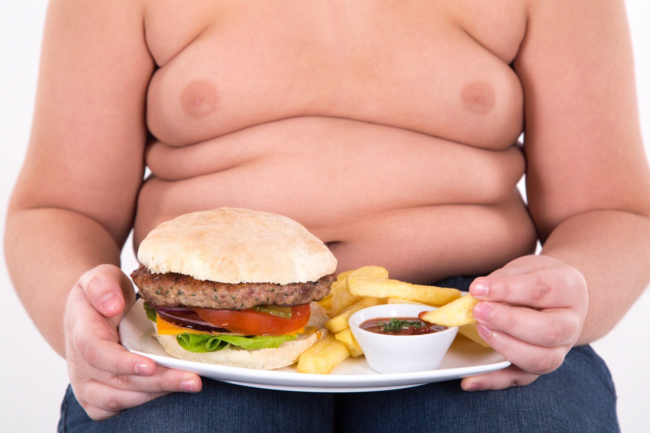 Obese child with hamburger and fries