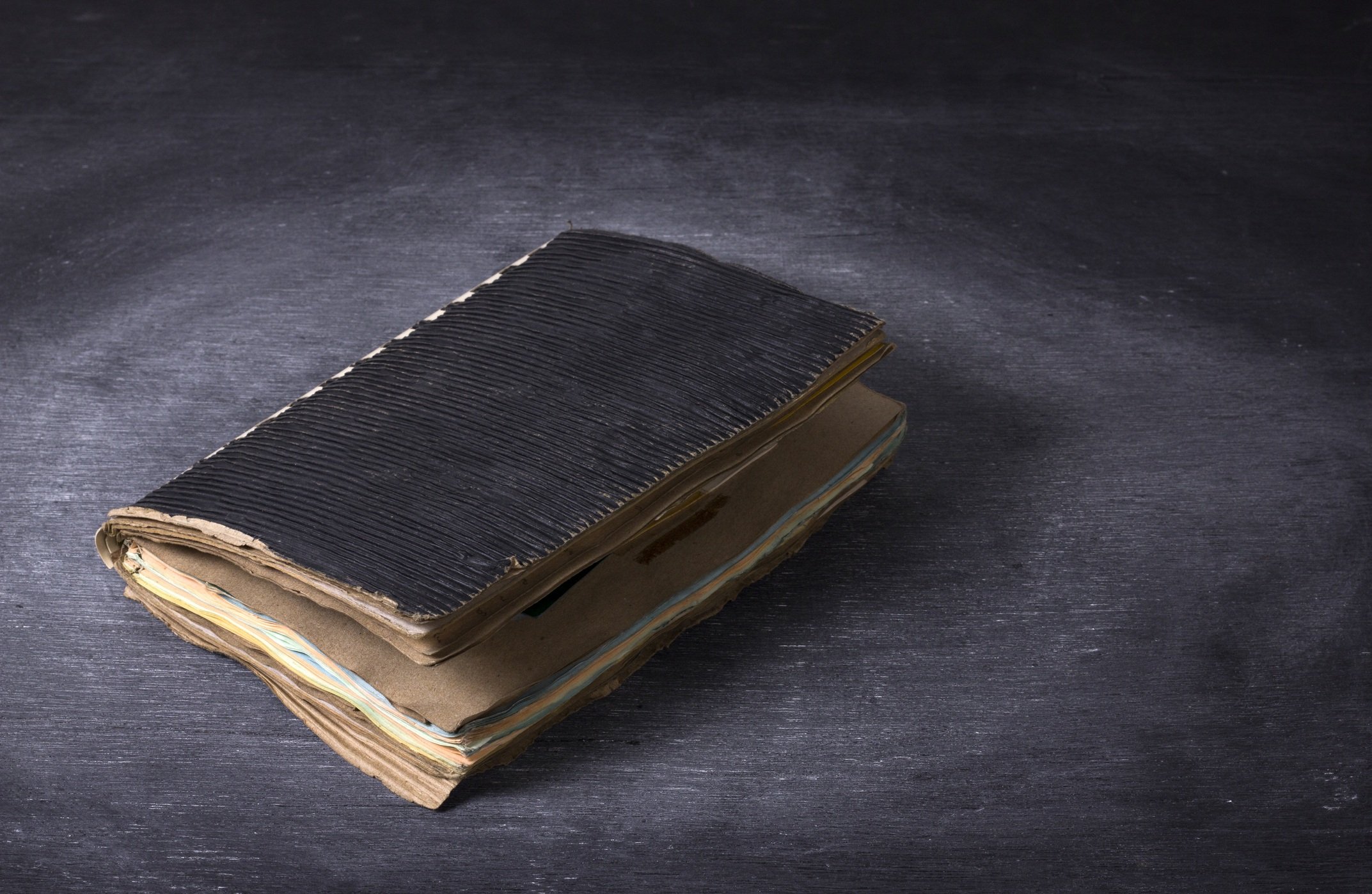Ancient notebook open on the wood texture.