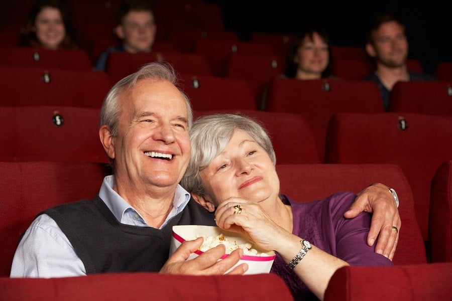 Senior couple at the movies watching a film 