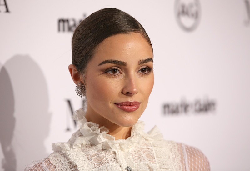 Olivia Culpo posing on a red carpet. Olivia Culpo posing on a red carpet.