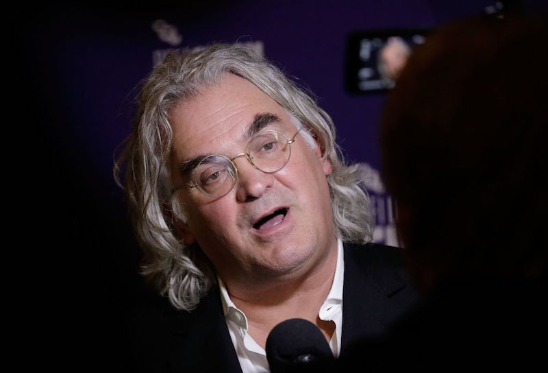 Paul Greengrass being interviewed by press on a red carpet. 